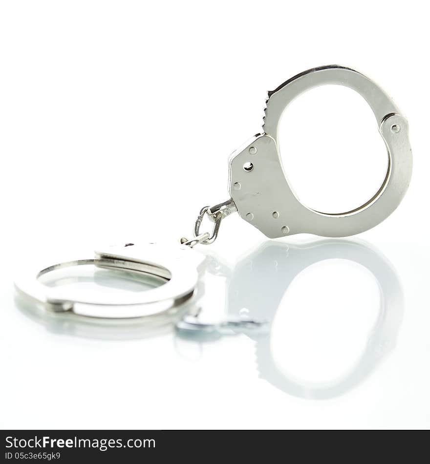 Handcuffs with shadow on a white background