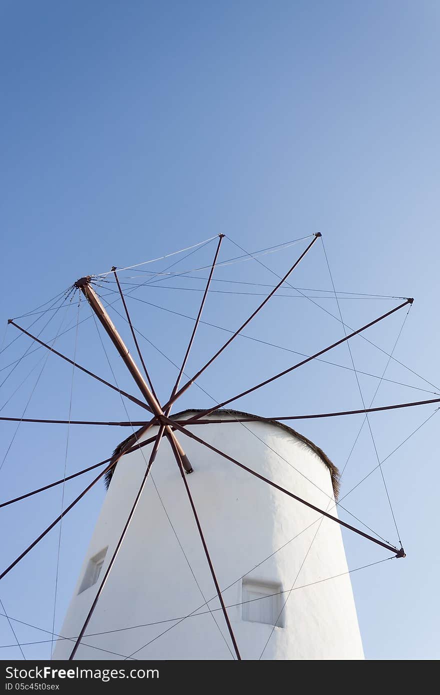 Traditional windmill of Santorini and blue sky.