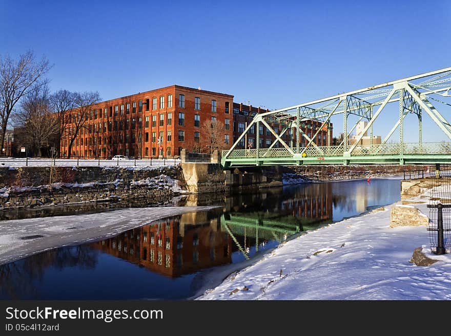 Reflection of bridge and building on water on a winter afternoon. Reflection of bridge and building on water on a winter afternoon