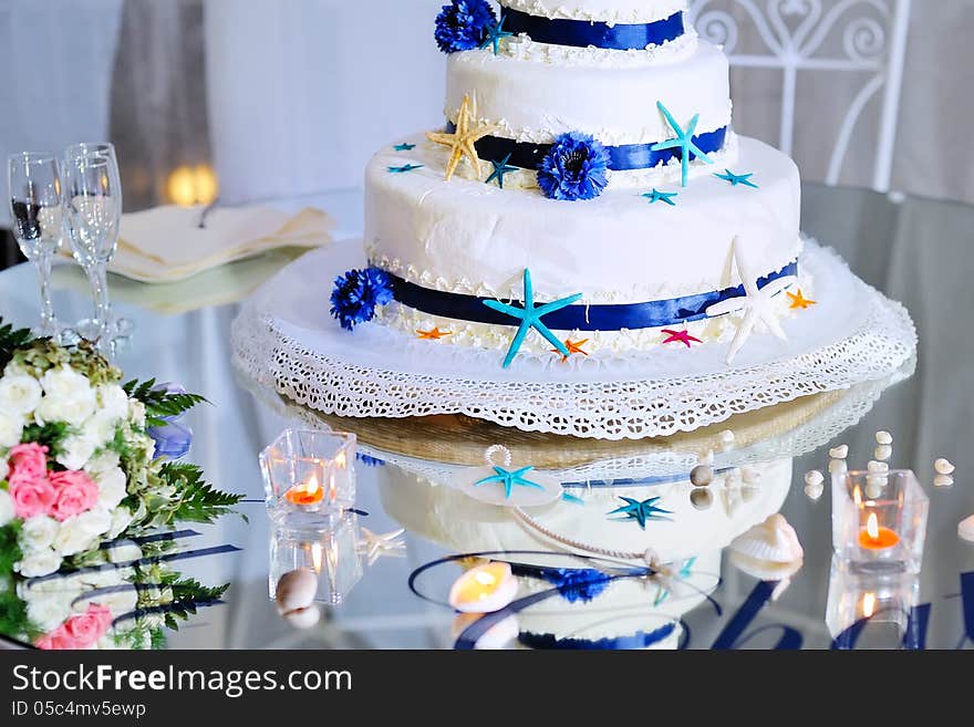 Eatiful decorated wedding cake with bride's bouquet and stemware. Eatiful decorated wedding cake with bride's bouquet and stemware