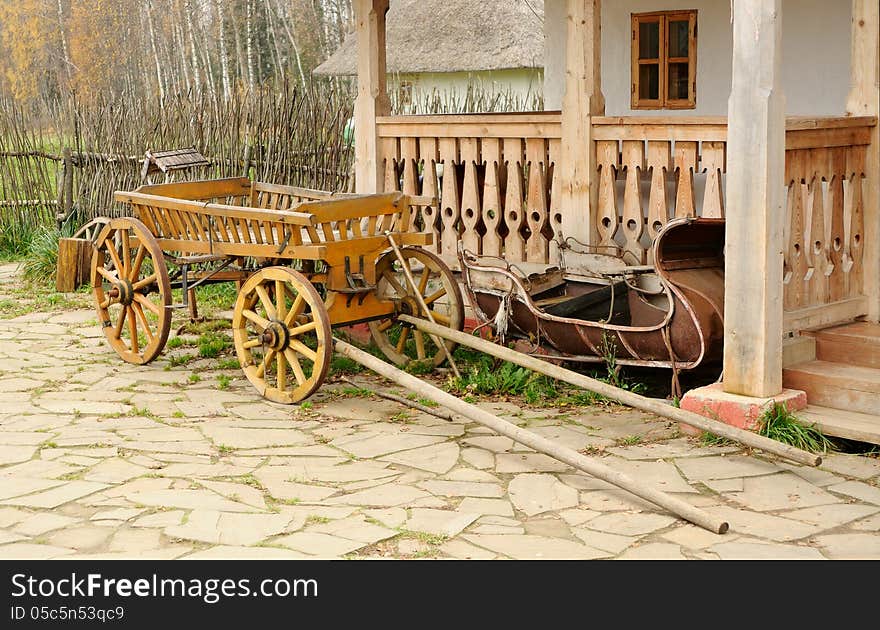 Cart and aged sledge about a porch