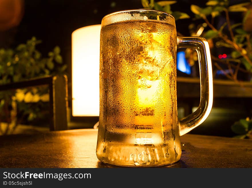 Glass of light beer at bar