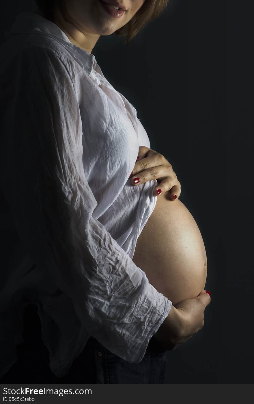 Pregnant woman holding her big belly. Pregnant woman holding her big belly