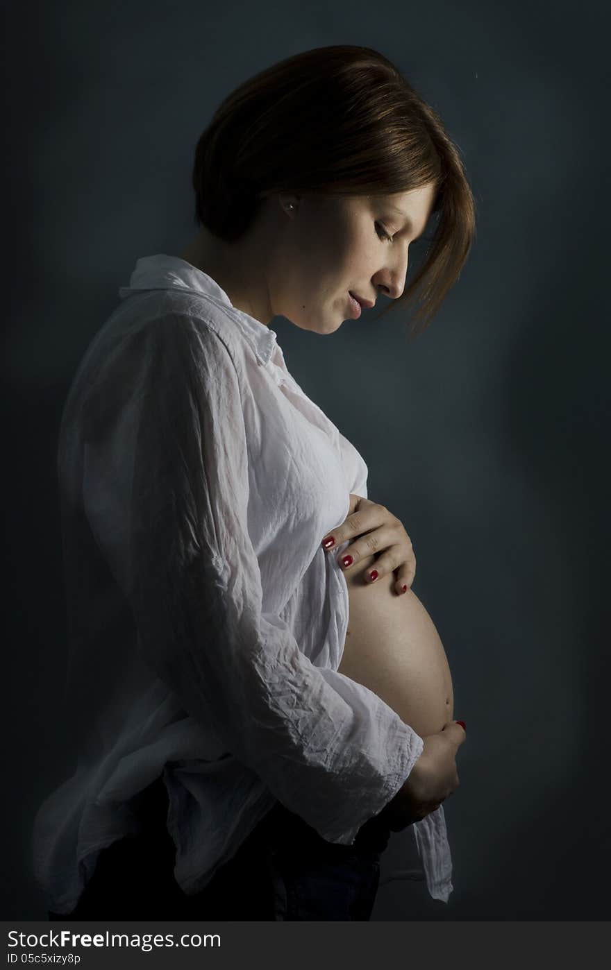 Pregnant woman holding her big belly. Pregnant woman holding her big belly