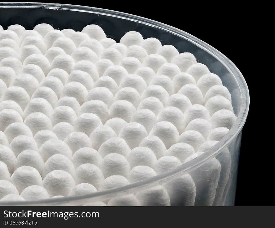 Packing cotton buds on a black background.