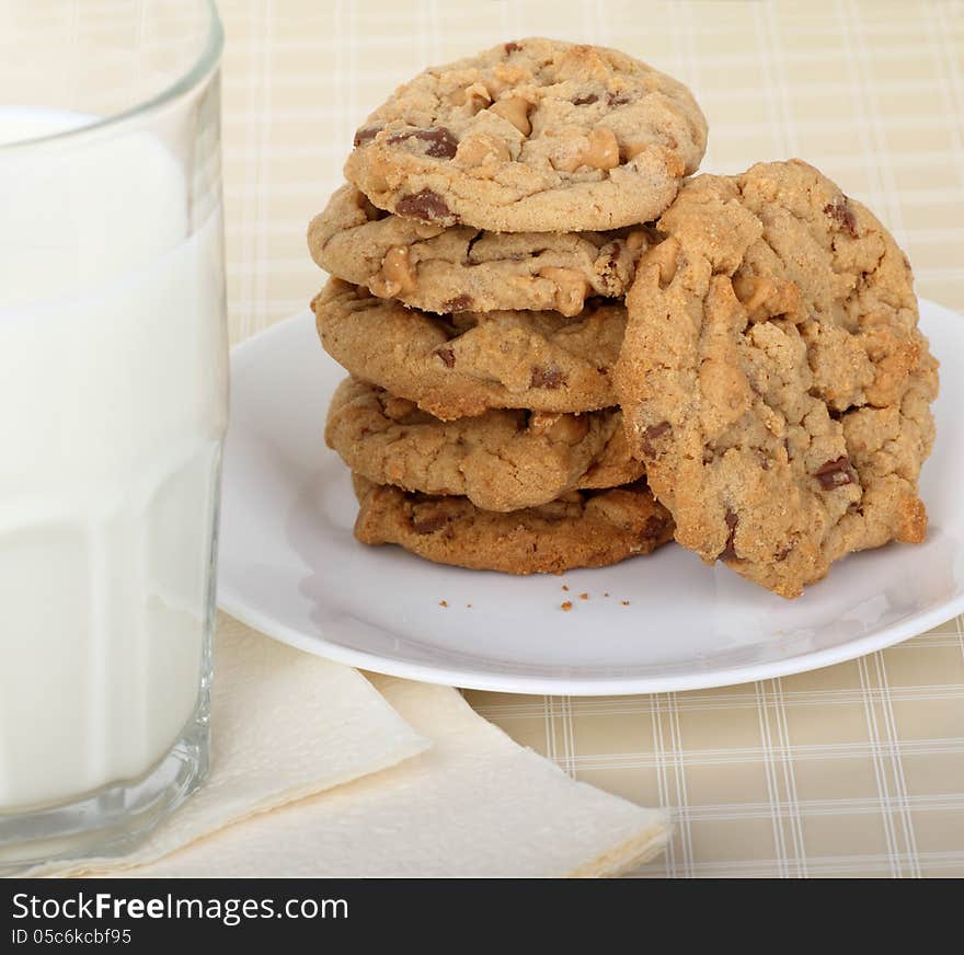 Peanut butter cookies stacked on a plate with glass of milk. Peanut butter cookies stacked on a plate with glass of milk