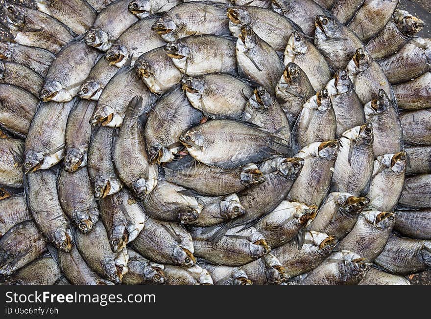 Spiral of dry fishes at a street food market in Saigon, Vietnam. Spiral of dry fishes at a street food market in Saigon, Vietnam.