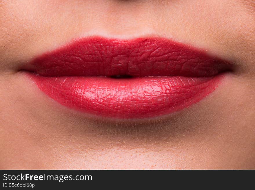 A high resolution image of Female lips with red lipstick