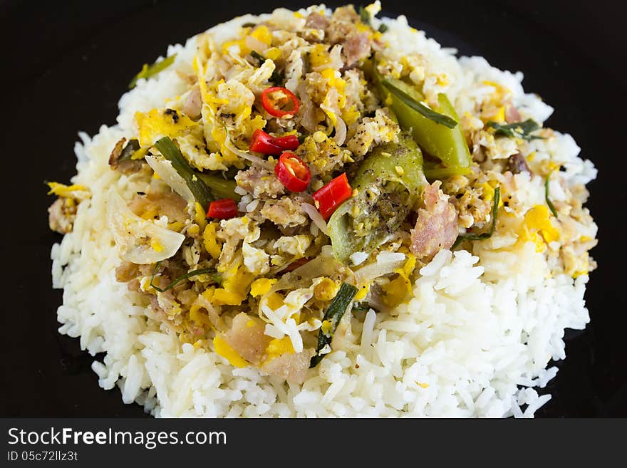 Fermented port fried rice on black plate