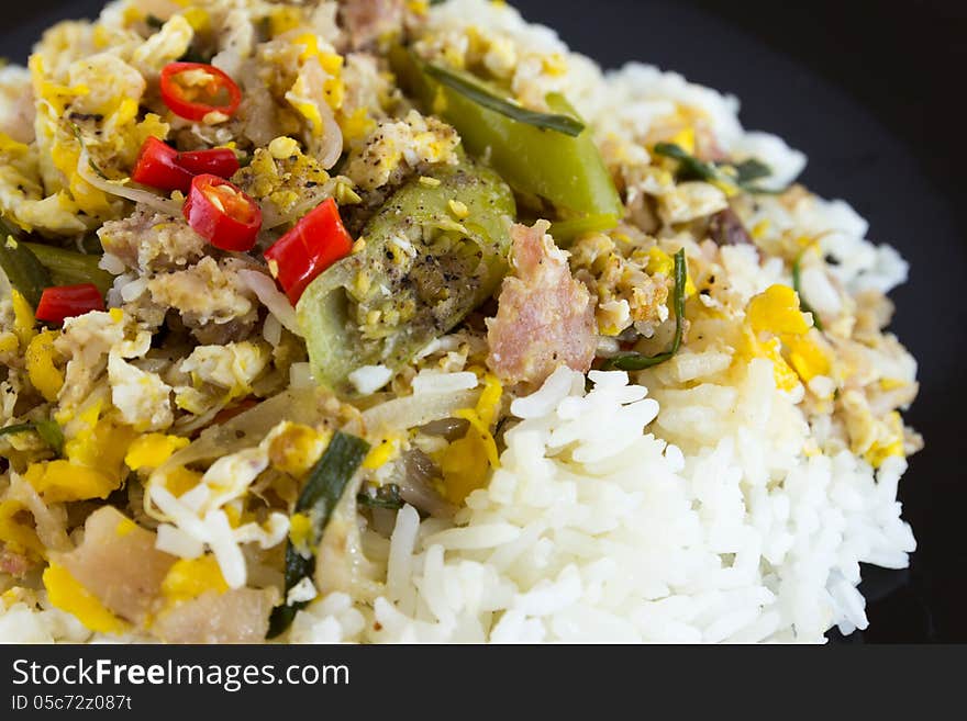 Fermented port fried rice on black plate