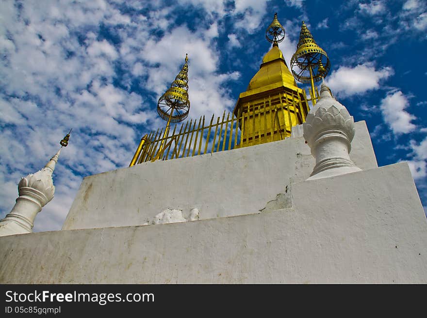 Luang Prabang, Laos, December 2012. Phu Si is a 100m high hill in the centre of Luang Prabang. After climbing 328 stairs, we reach the summit of the hill, where we find Wat Chom Si, a Buddhist temple, which is one of the main attactions of this old town. The gilded stupa of Wat Chom Si seems to be looking at the sky. Luang Prabang, Laos, December 2012. Phu Si is a 100m high hill in the centre of Luang Prabang. After climbing 328 stairs, we reach the summit of the hill, where we find Wat Chom Si, a Buddhist temple, which is one of the main attactions of this old town. The gilded stupa of Wat Chom Si seems to be looking at the sky.