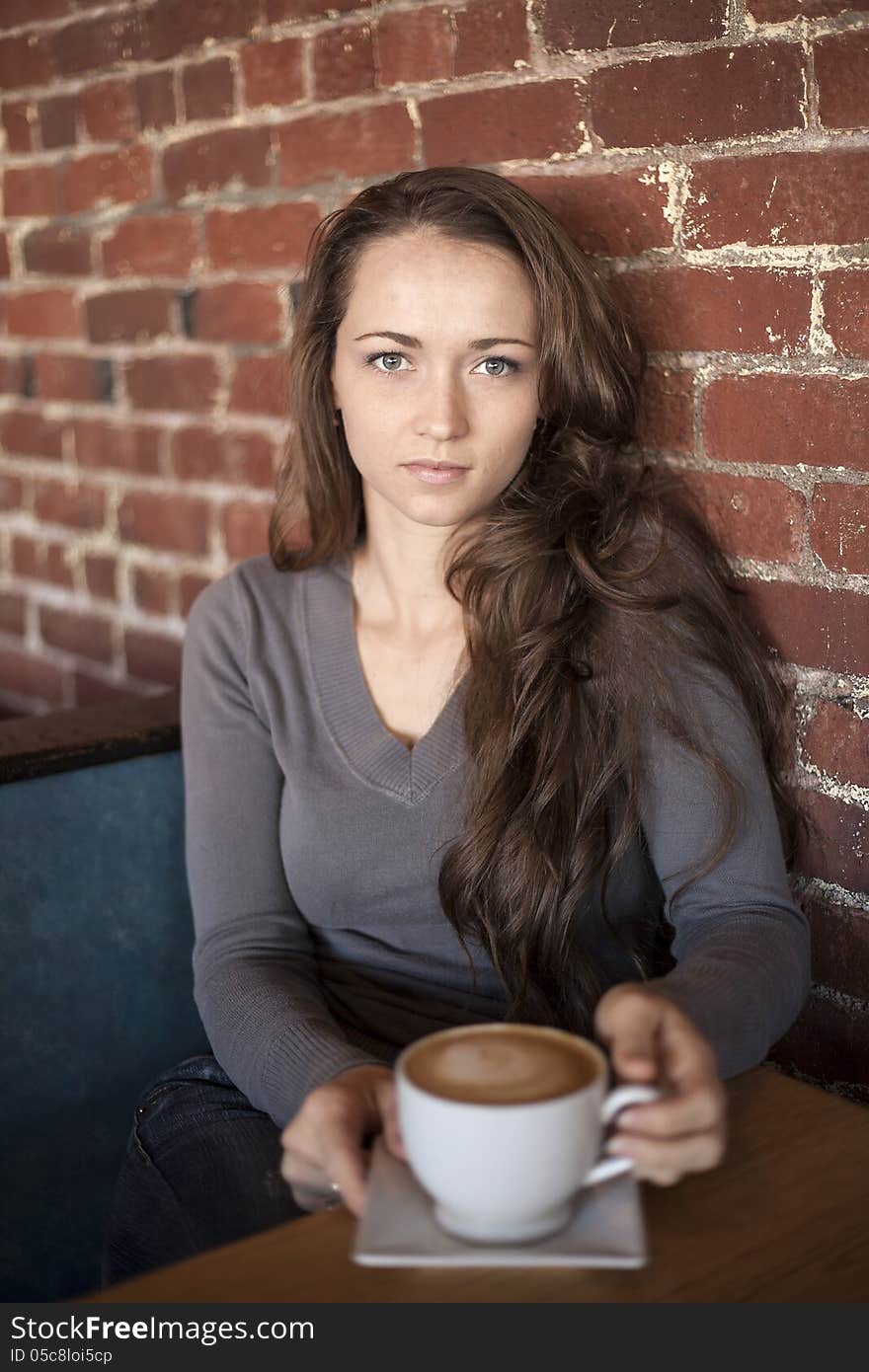 Young Woman with Beautiful Green Eyes with White Coffee Cup