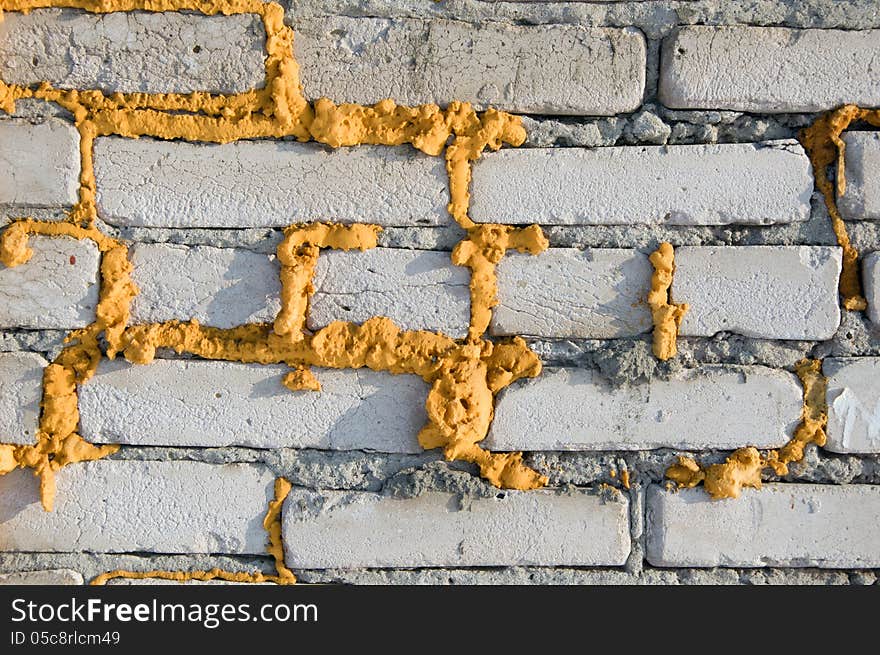 Texture of gray brick wall with a yellow foam. Texture of gray brick wall with a yellow foam.