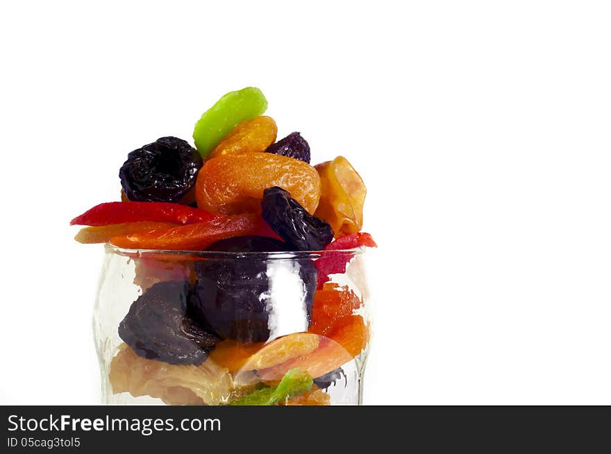 Dried fruits in a glass on a white background.close up