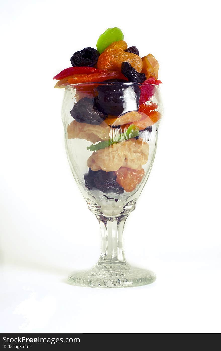 Dried fruits in a glass on a white background