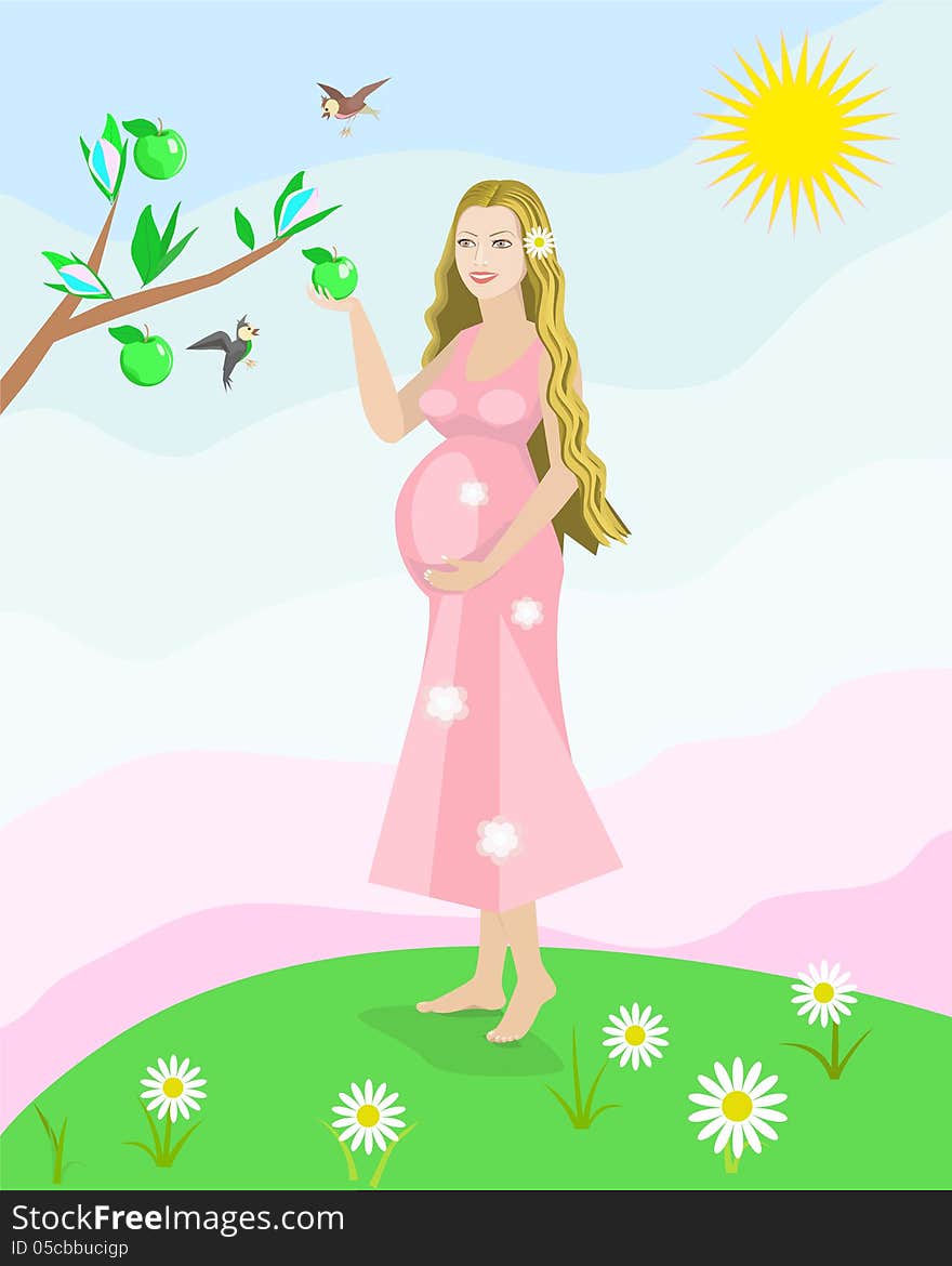 Pregnant woman standing in a meadow and keeps a green apple in her hand