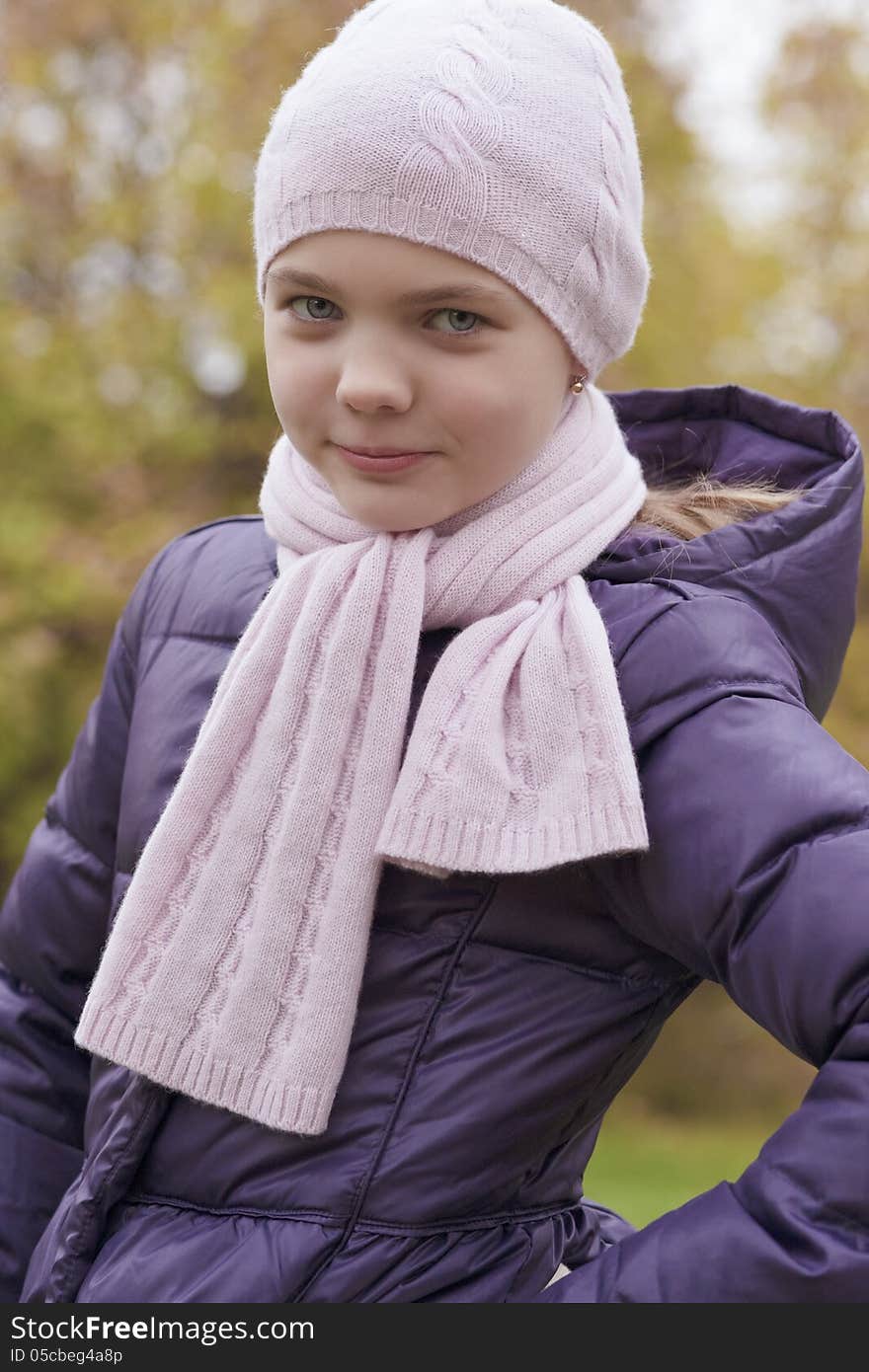 Portrait of young caucasian little girl walking in autumn park