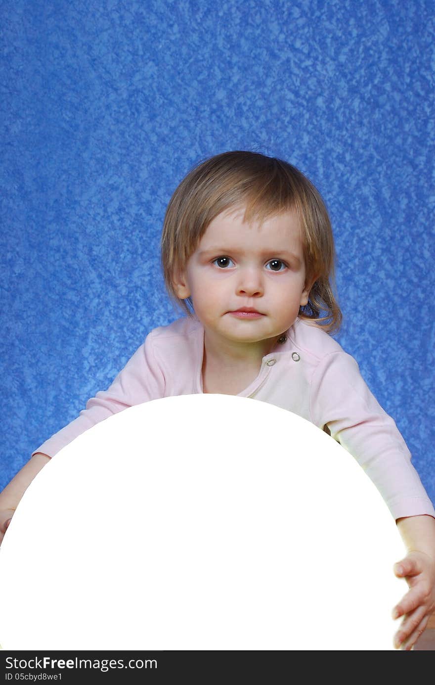 Child with ball, portrait on a blue background