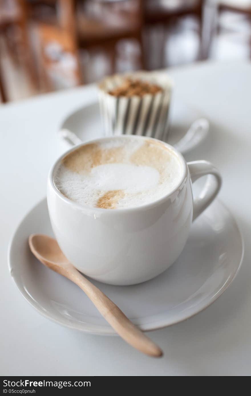 A cup of coffee on a white desk