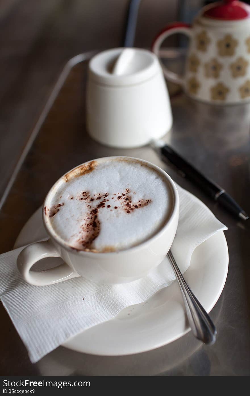 A cup of coffee on a desk