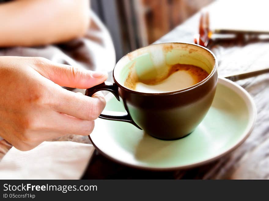 Female hand holding cup of coffee. Female hand holding cup of coffee