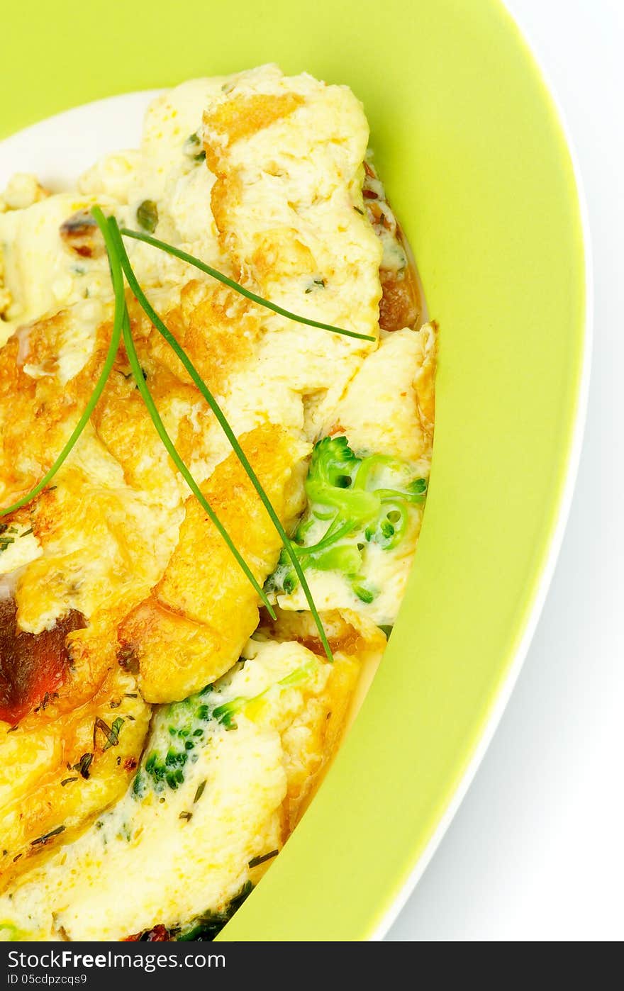 Delicious Omelet with Broccoli and Spring Onion on Green Plate closeup