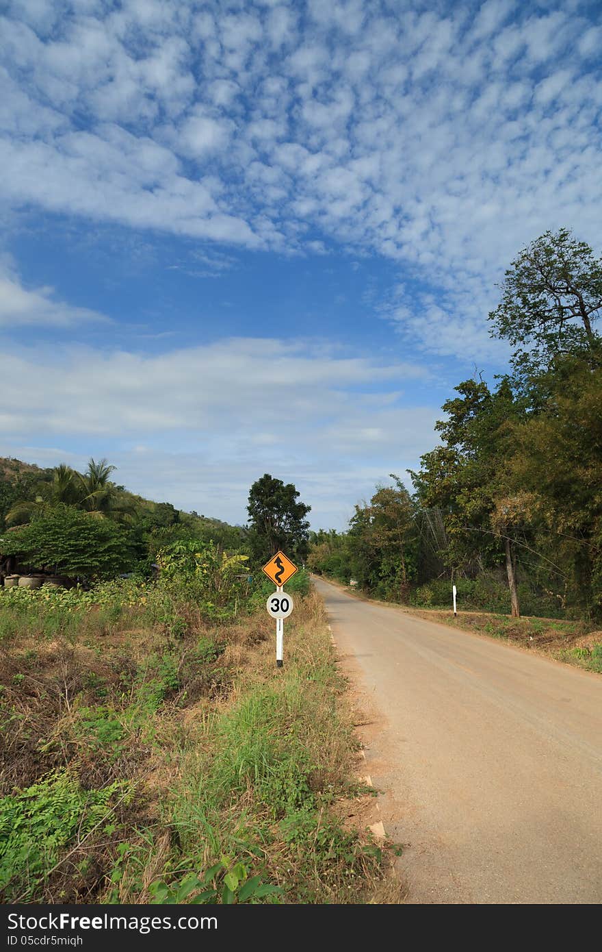 Country Road In A Rural Area With A Traffic Sign