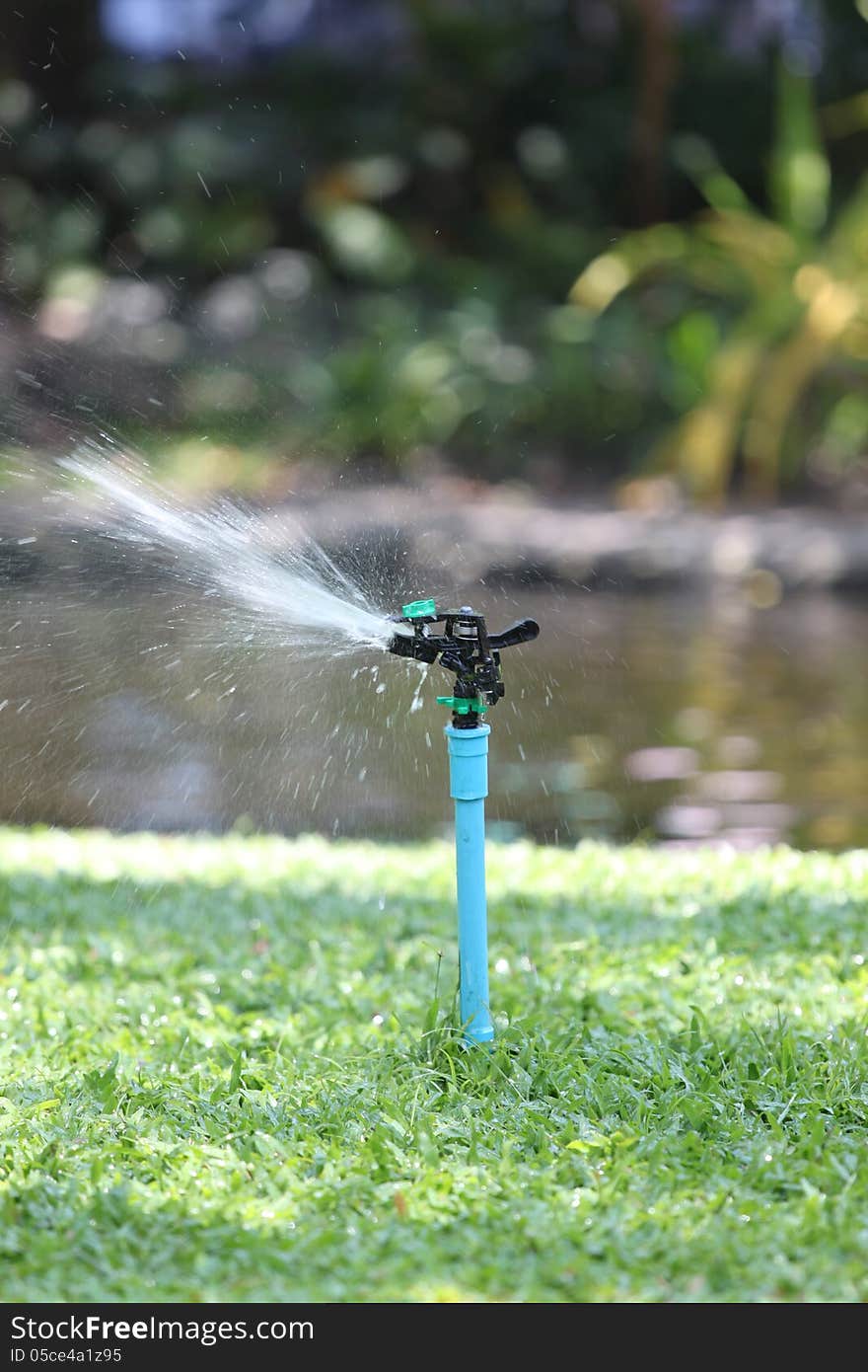 Photo of a Sprinkler in action on a water. Photo of a Sprinkler in action on a water.