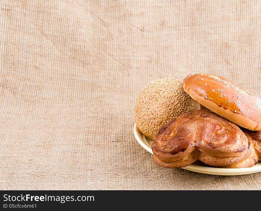 Bread Rolls With Sesame Seeds On A Plate