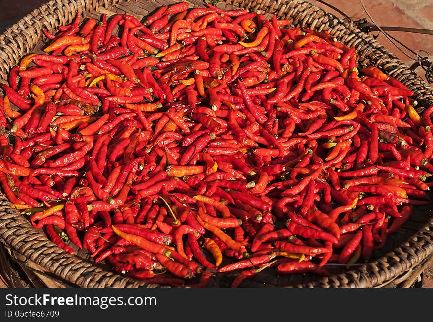 A basket of hot red chili peppers at Laos market. A basket of hot red chili peppers at Laos market