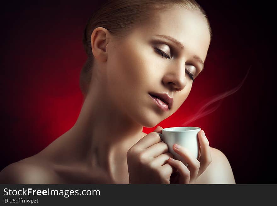 Sexy Woman Enjoying A Hot Cup Of Coffee On A Dark Background