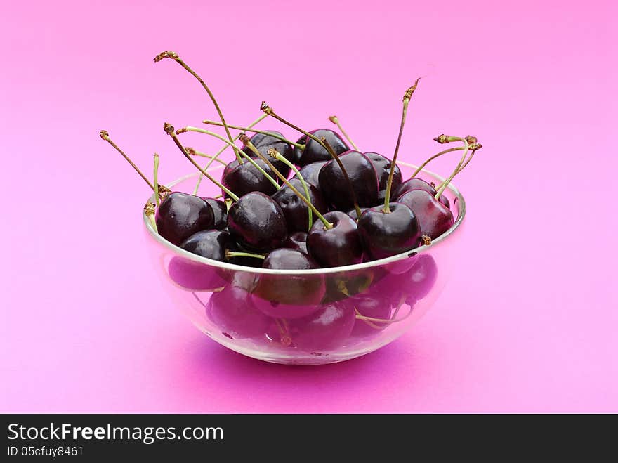 Fresh cherries bowl on pink background. Fresh cherries bowl on pink background.