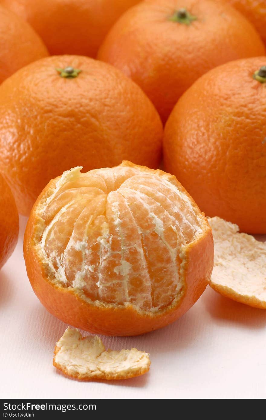 Peeled mandarin on fruits background. Peeled mandarin on fruits background.