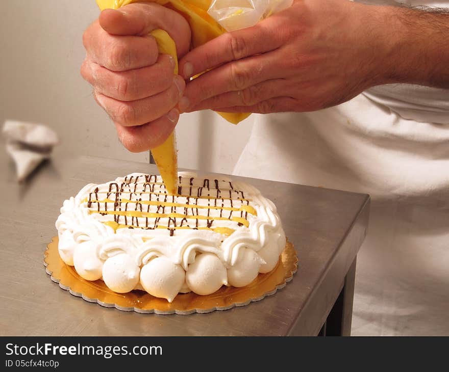 Chef hands preparing cream cake. Chef hands preparing cream cake.