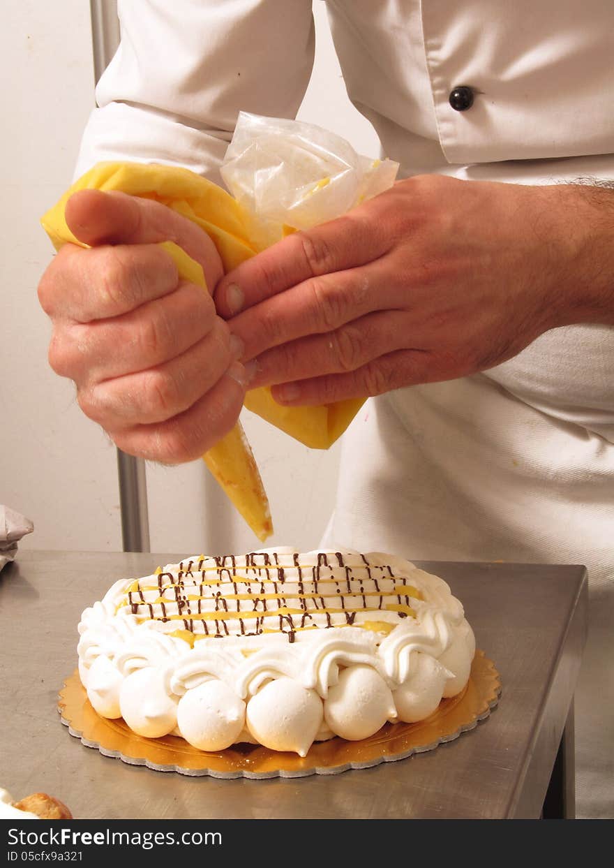 Chef hands preparing cream cake. Chef hands preparing cream cake.