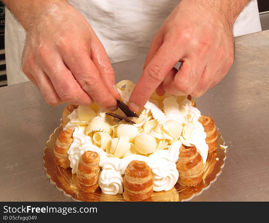 Chef hands preparing white cream cake. Chef hands preparing white cream cake.