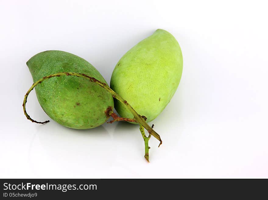 A Green mango on white Background.