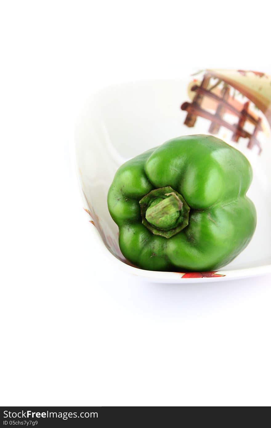 The Green Bell peppers in Dish on white Background. The Green Bell peppers in Dish on white Background.