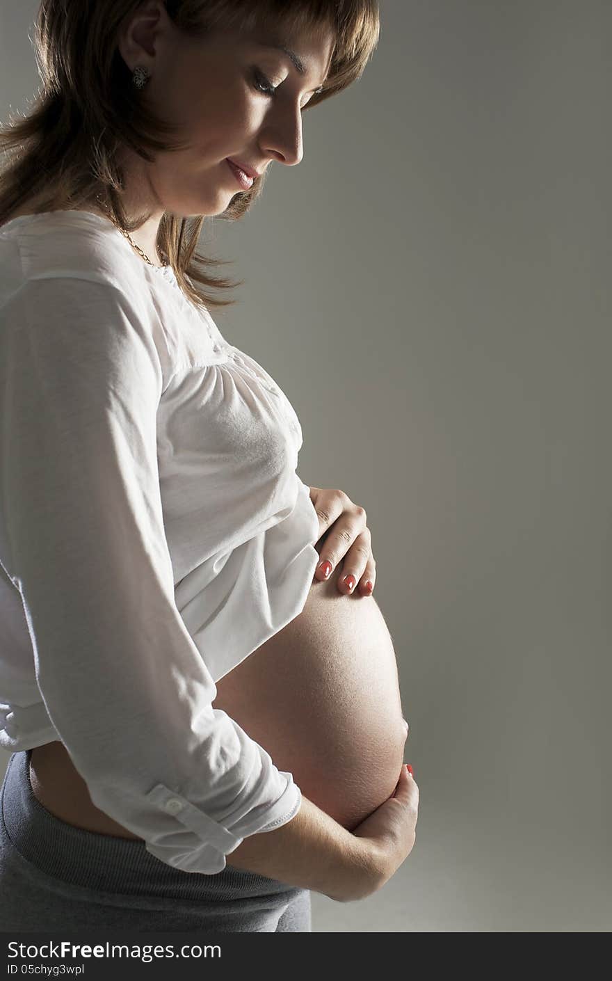 Young pregnant Woman Holding Belly