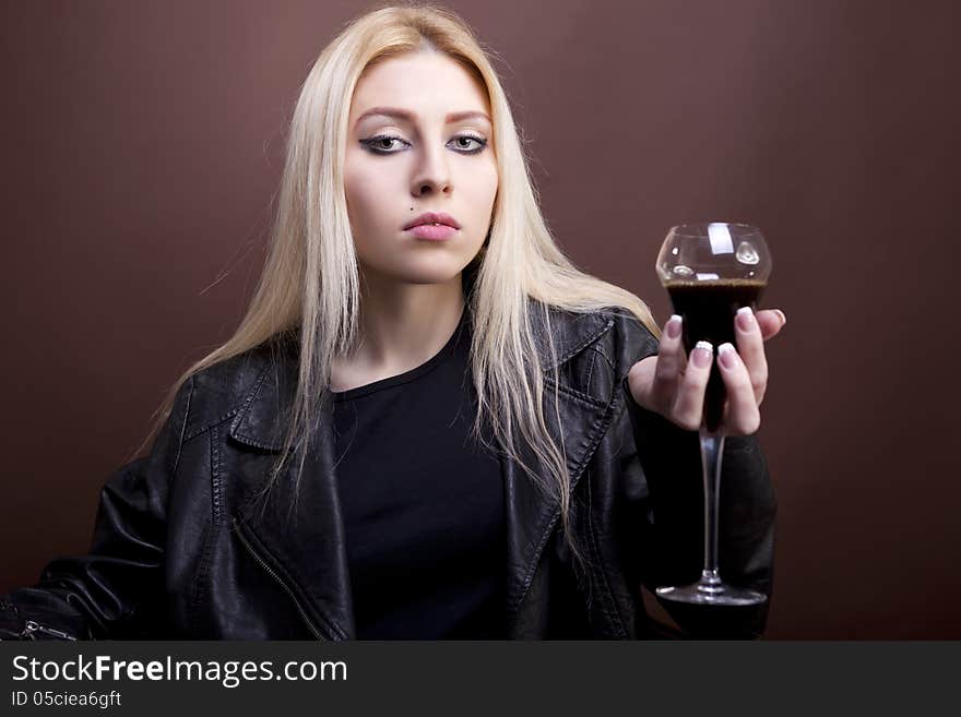 Portrait of beautiful caucasian girl with a glass in her hand studio shot