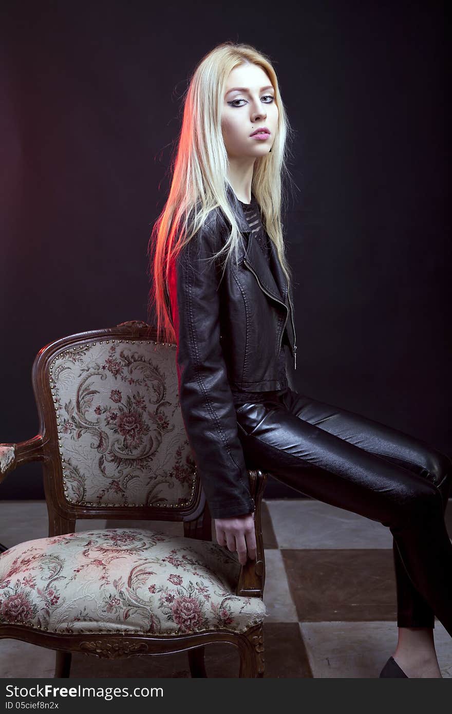 Beautiful girl sitting on a vintage chair