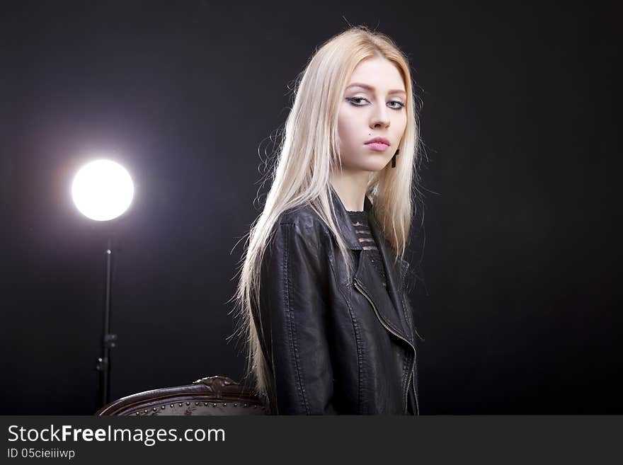 Gorgeous blonde with a light behind her studio shot