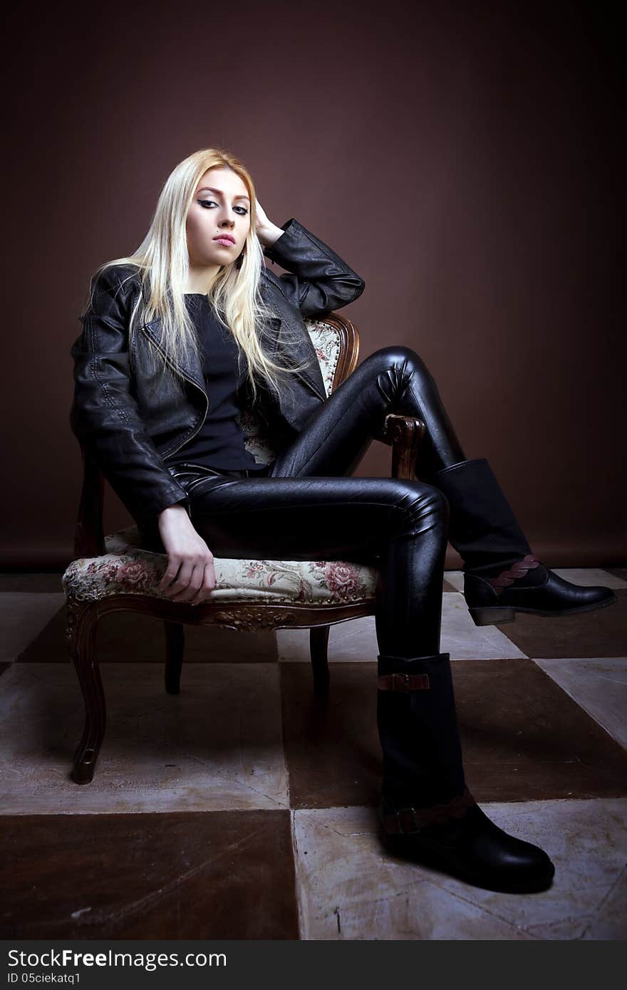 Gorgeous girl sitting on a vintage chair