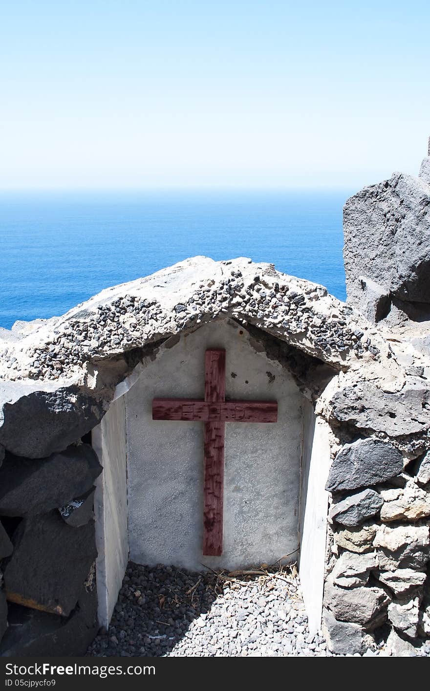 Wooden cross with the sea and the sky