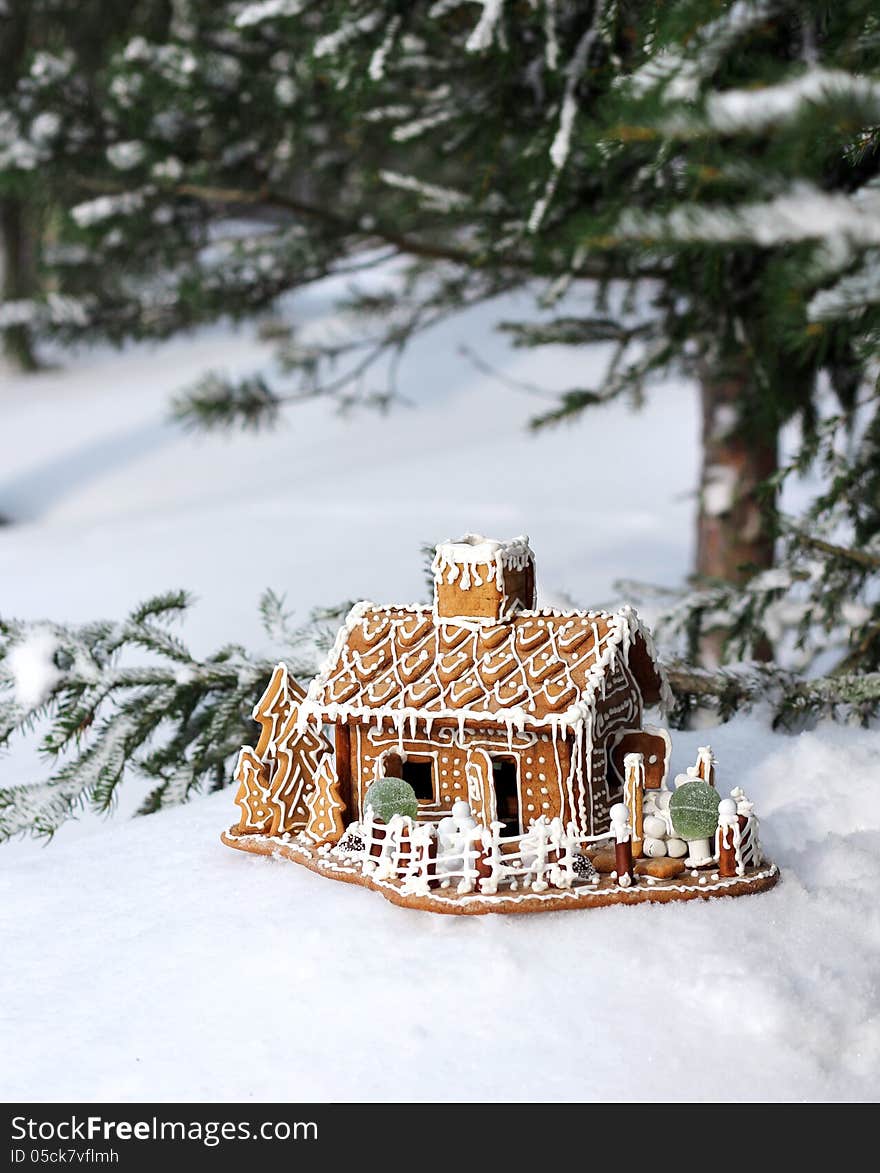 Gingerbread house in real snowy forest