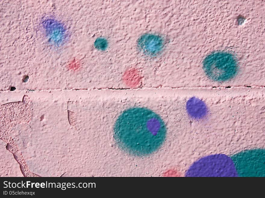 Colored polka dots on a pink wall. Colored polka dots on a pink wall