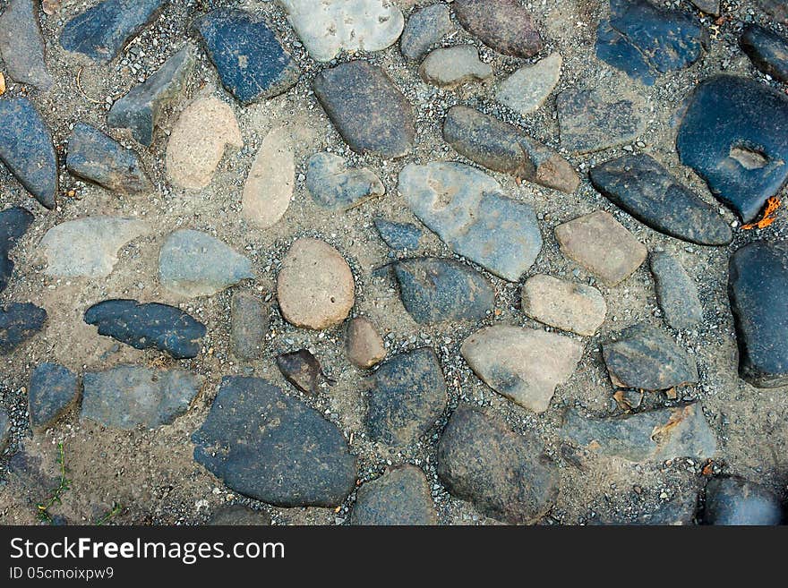 Irregular texture of the old blue gray stone wall outside