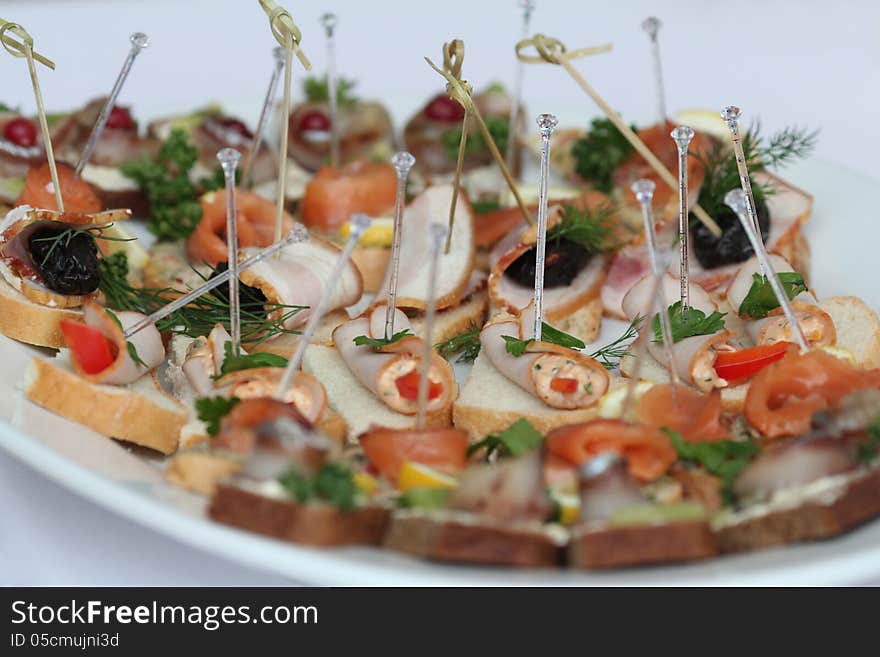 Canapes with skewers and sandwiches