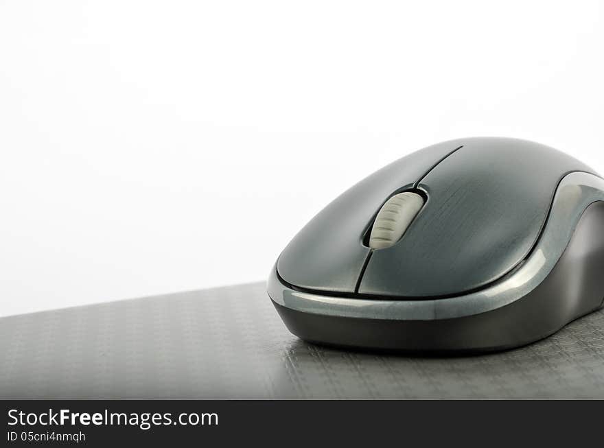 Wireless computer mouse on a metallic background