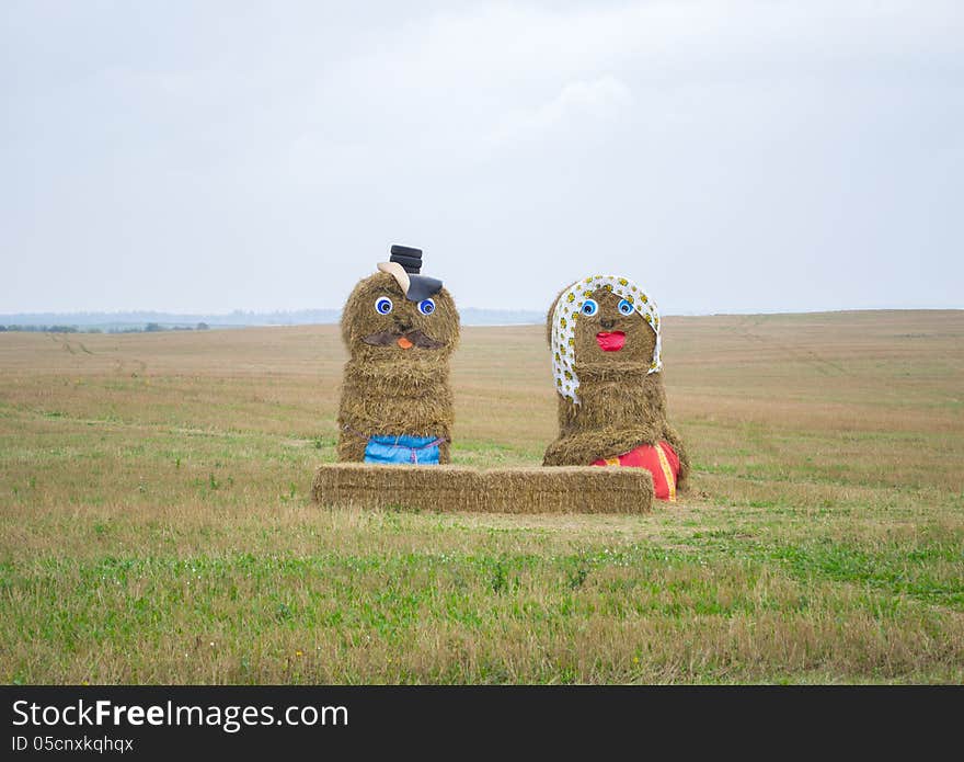 Cute figures made of hay in the field. Cute figures made of hay in the field